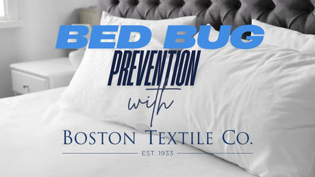 Image shows a picture of a white bed with fluffy pillows. Text overlays it saying "Bed Bug Prevention with Boston Textile Co." in blue writing and variety of fonts.