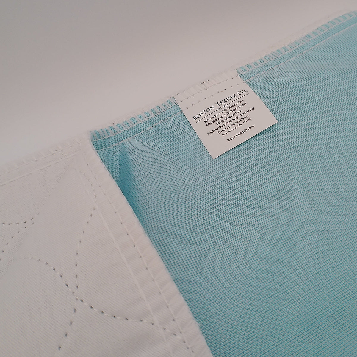 Pictured: Twill Underpad's tag - Boston Textile Co 50% Cotton / 50% Polyester Face
95% Polyester 5% Rayon Soaker
100% Polyester Back
Machine Wash Separately - Tumble Dry
Do not use Fabric softener