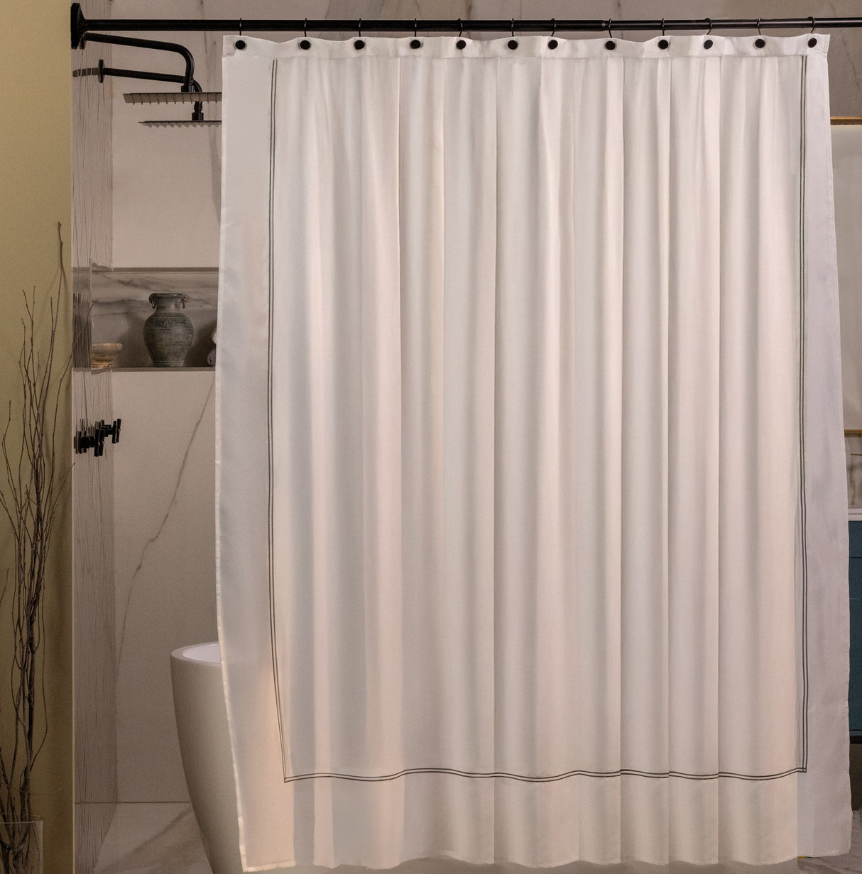Beige shower curtain with black trim in a bathroom setting