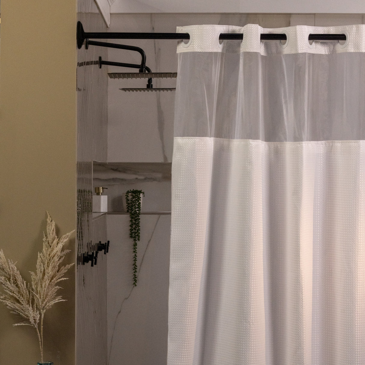 Sheer shower curtain with grommets in a bathroom setting
