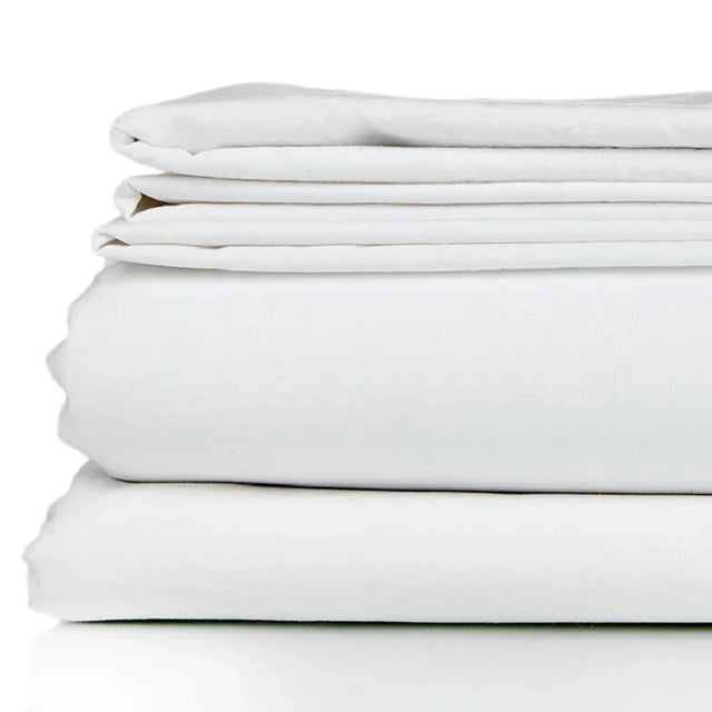 White bed sheet set neatly folded. Product shot.