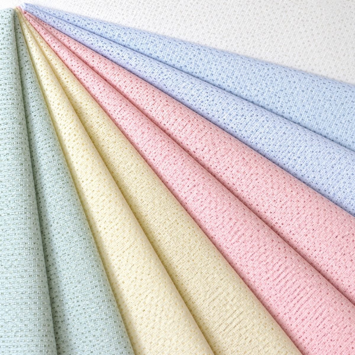 Pictured: Bariatric Knitted Fitted Sheets laid on top of each other so that the colors are peeking out. The colors from left to right are: seafoam, yellow, red, blue, white.
Note: We only carry seafoam and white.