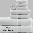 Product showcases Blackfin by Boston Textile Co. A selection of hotel towels for wholesale supply. White in color. Product is neatly rolled and placed from size of wash cloths, to hand towels to bath towels.