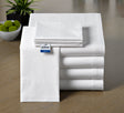 Folded white bed sheets with a Bluefin logo on a wooden surface