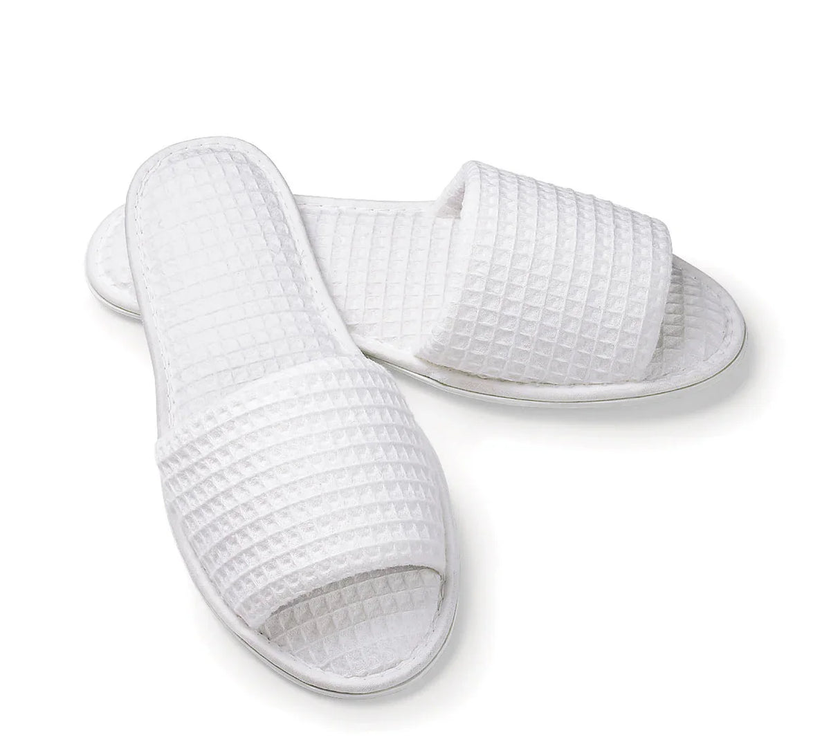 Open toe waffle slippers product shot in a white background. Sold by a wholesale supplier for hotels, healthcare and hospitality.