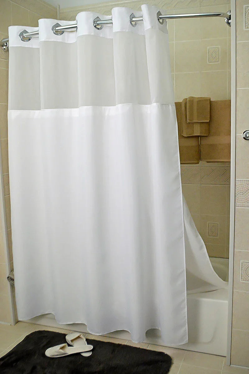 Product showcases a shower curtain in a hotel bathroom. It is white in color. Available for wholesale supply.