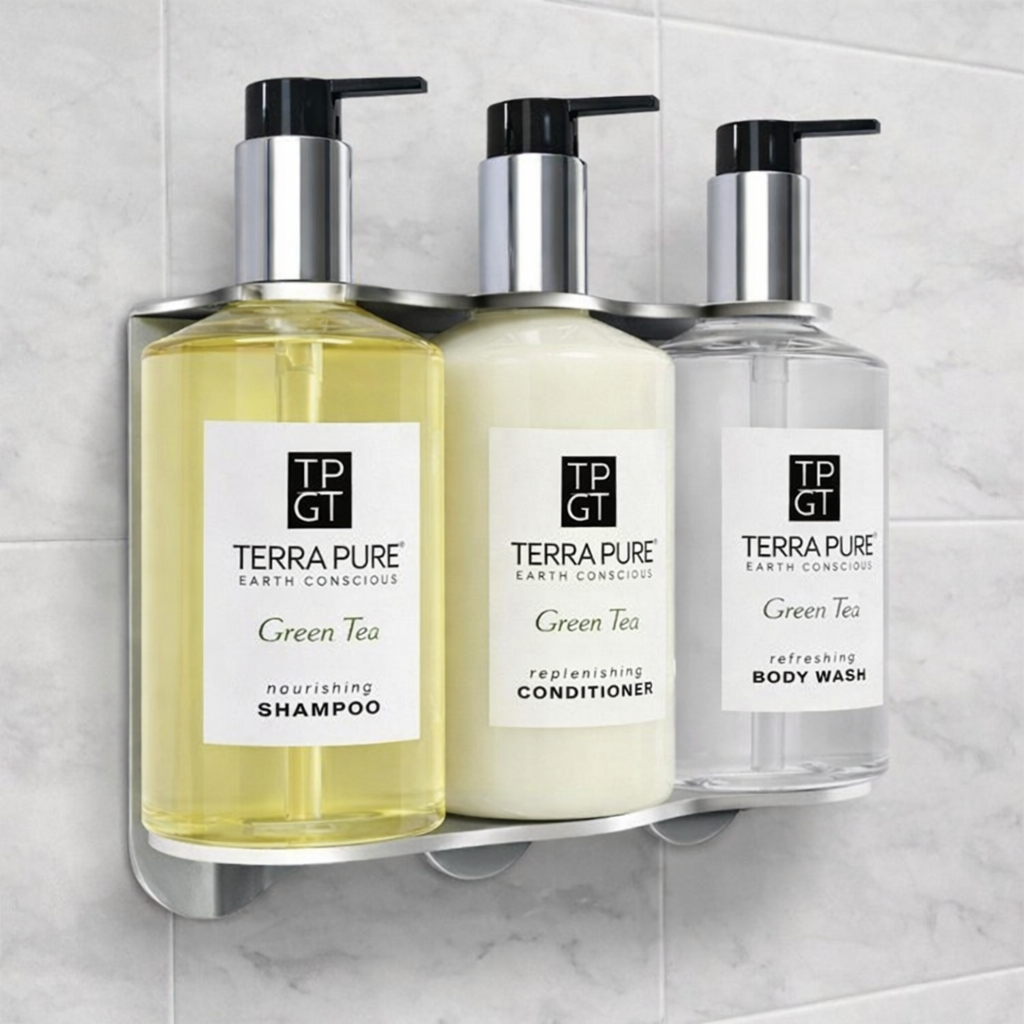Three Terra Pure Green Tea products on a wall-mounted holder against a tiled wall.