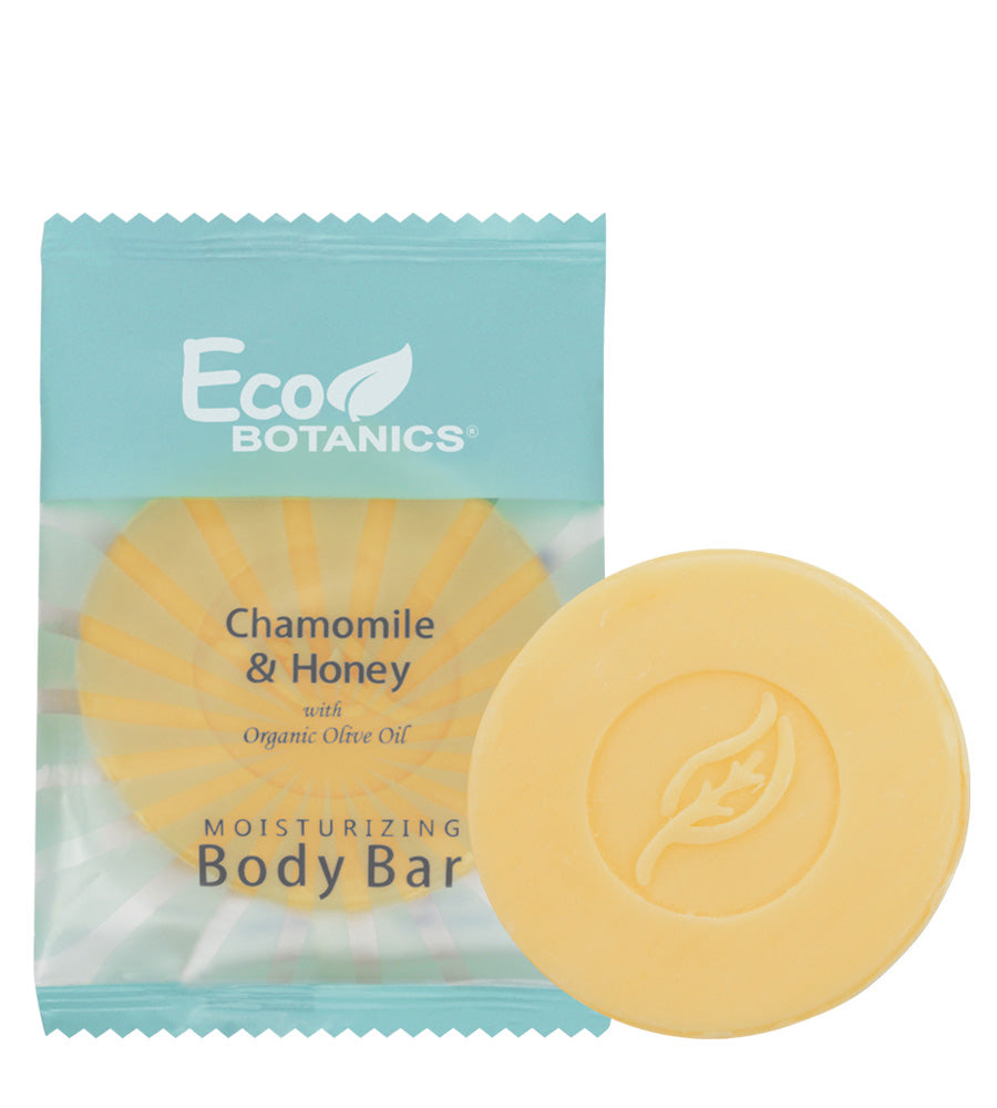 EcoBotanics hotel amenity body bar yellow cylinder with leaf detail. Chamomile and honey with organic olive oil. Product shot with white background.