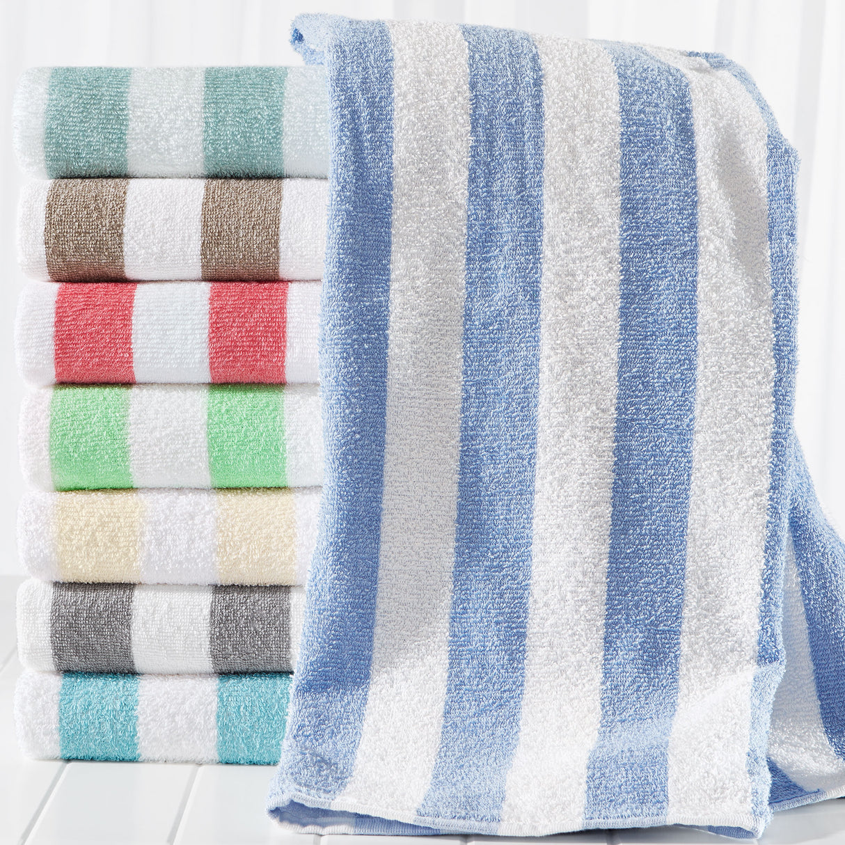Stack of folded towels with blue and white stripes on a white background
