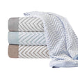 Product photoshoot of multiple hotel linen towels folded on top of eachother in a variety of colors. White background.