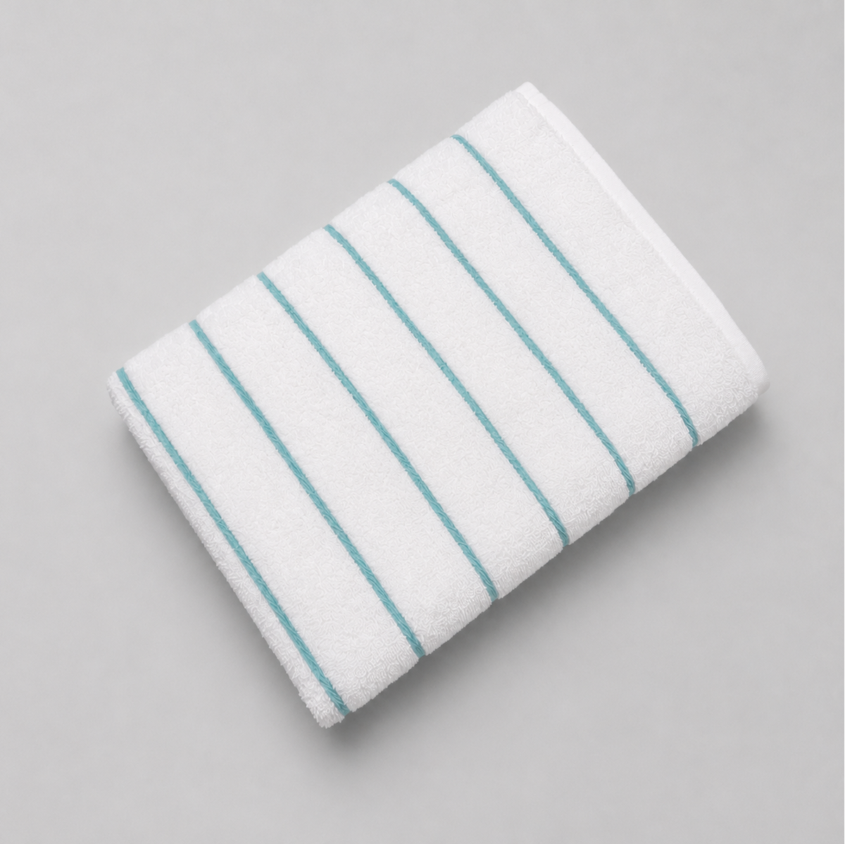 Pictured: Fibertone Twill Striped Pool Towel neatly folded against a white background. The stripes are colored and listed under the shade "Teal".