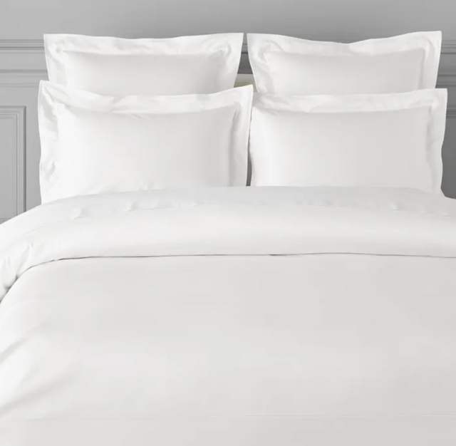 A white duvet cover displayed on a bed, with pillows covered in a matching white pillowcase.