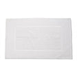 White textured bath mat on a white background