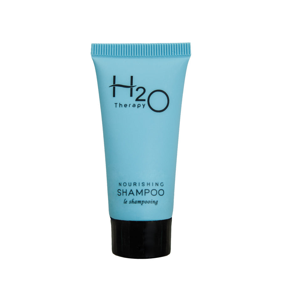 Pictured: H2O Therapy Nourishing Shampoo in a blue squeeze tube, standing up on the black cap against a white background.