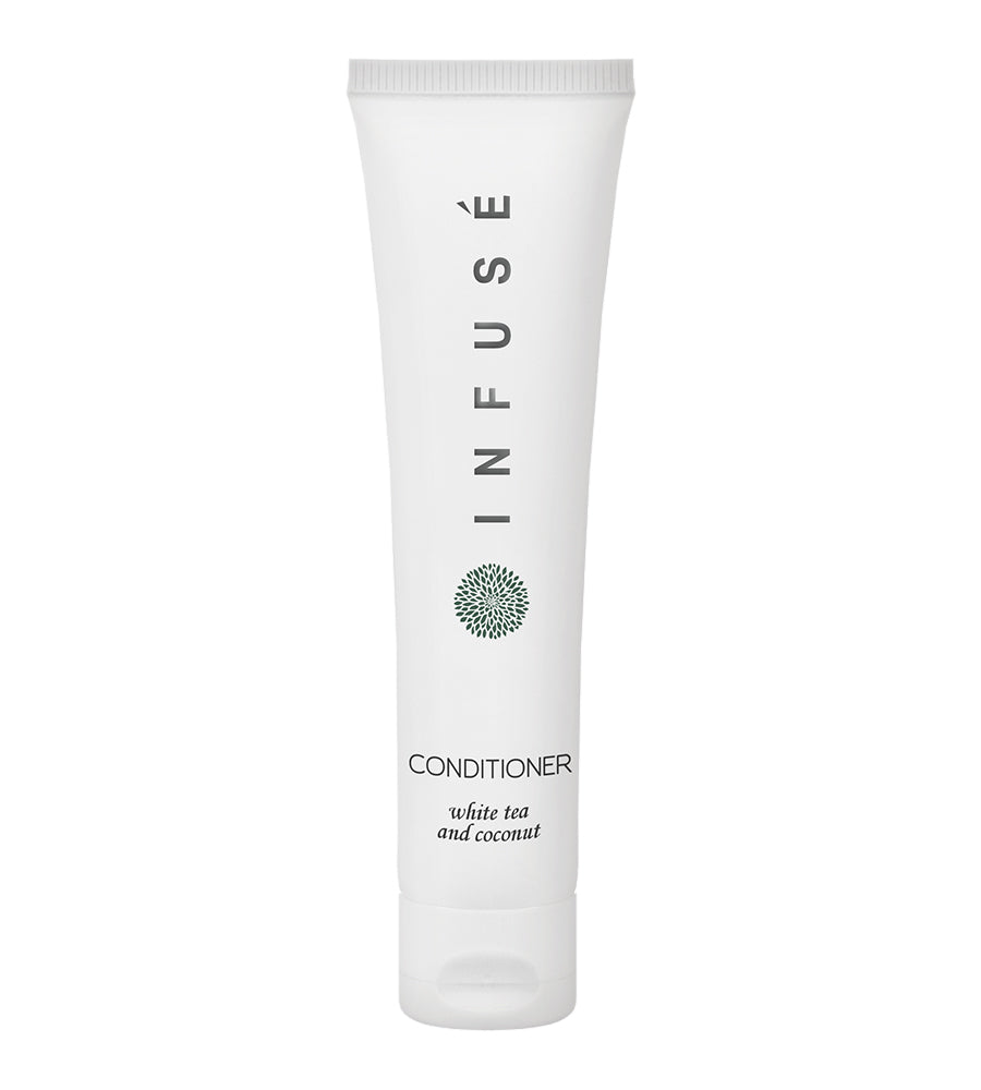 Product shot of infuse white hotel amenity collection conditioner with white tea and coconut. White background.