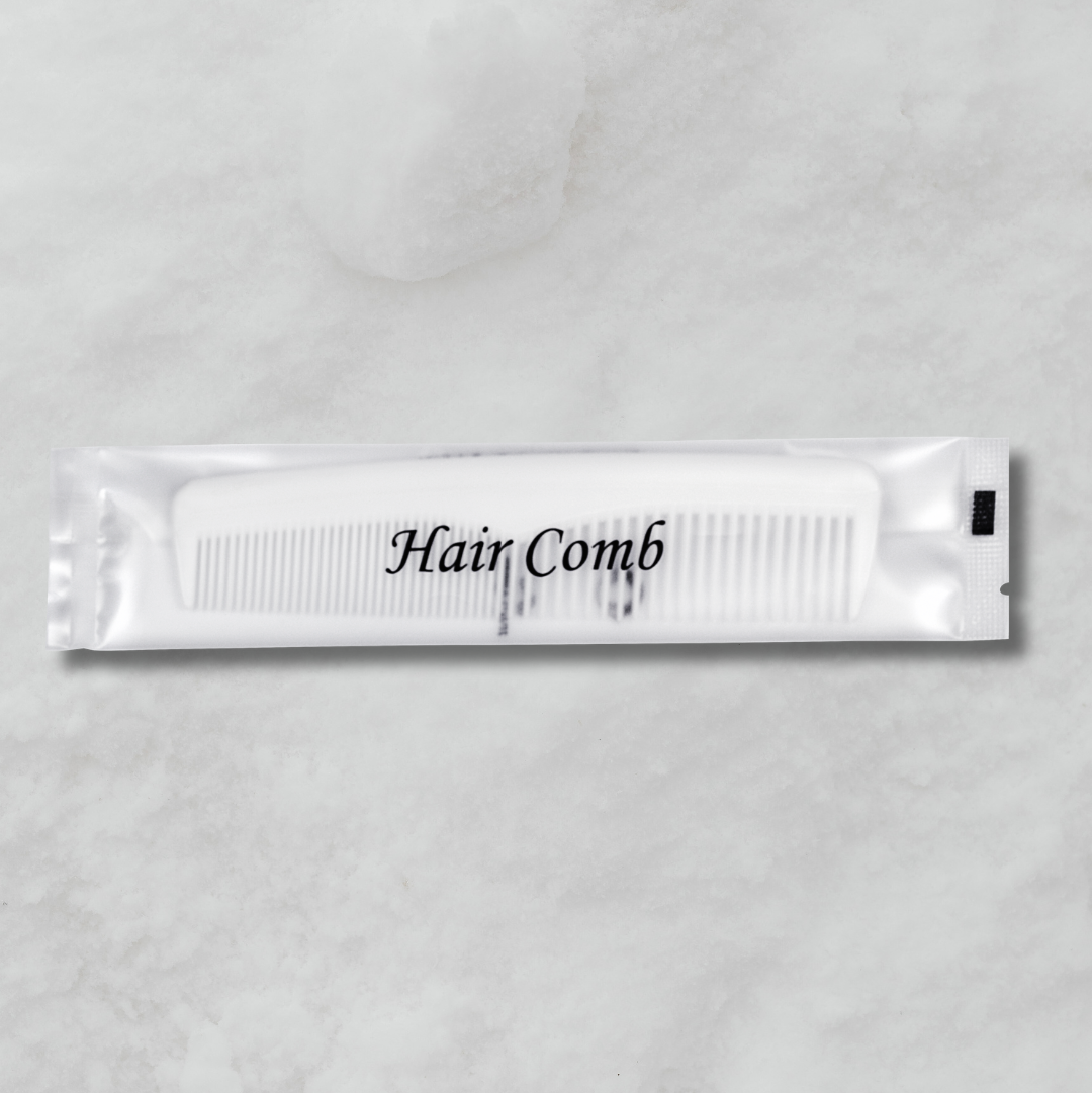 White comb packet labeled 'Hair Comb' on a gray background