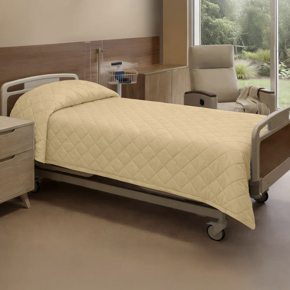 Beige hospital bed in a room with a window view of greenery