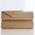 Folded beige blanket on a white background
