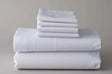 Product photo of bed sheet set. Product features pillowcases, flat sheets, bed sheets and fitted sheets. High quality linen. White background.