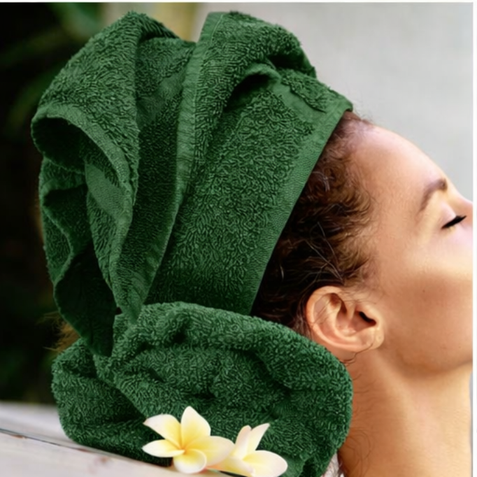 Person wearing a green towel on their head with a blurred background
