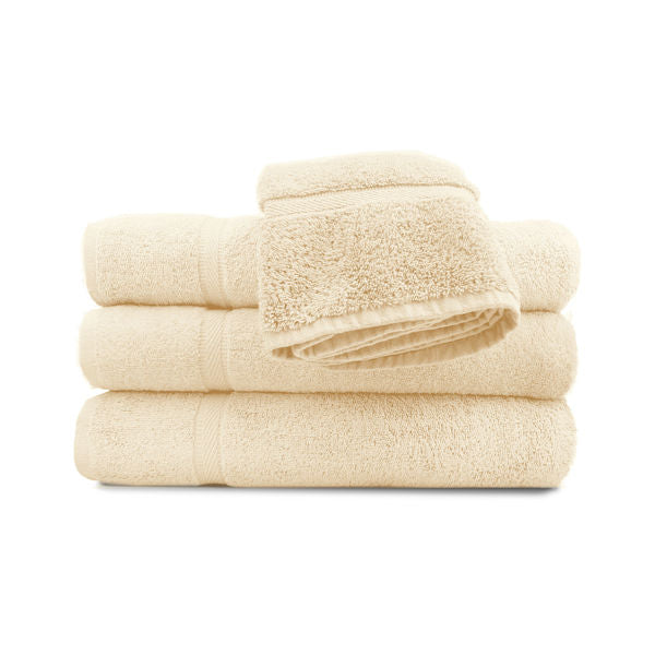 A set of beige pool towels stacked neatly, with a classic dobby border.