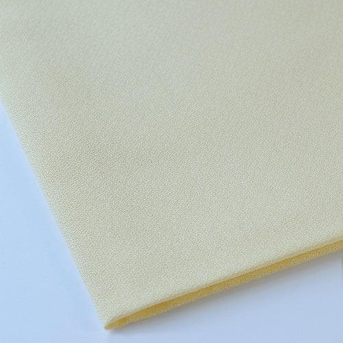 Close-up of a folded piece of light green fabric on a white background