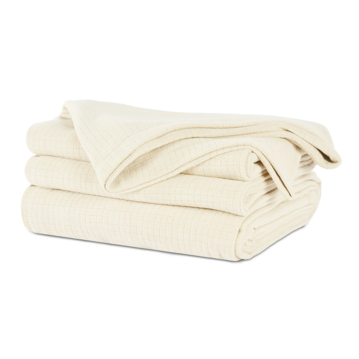 Cream colored fluffy and luxurious blanket neatly folded. Product shot.