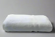 Product shot of healthcare towels in shade white, photo for wholesale supplier for healthcare, hotels and hospitality.