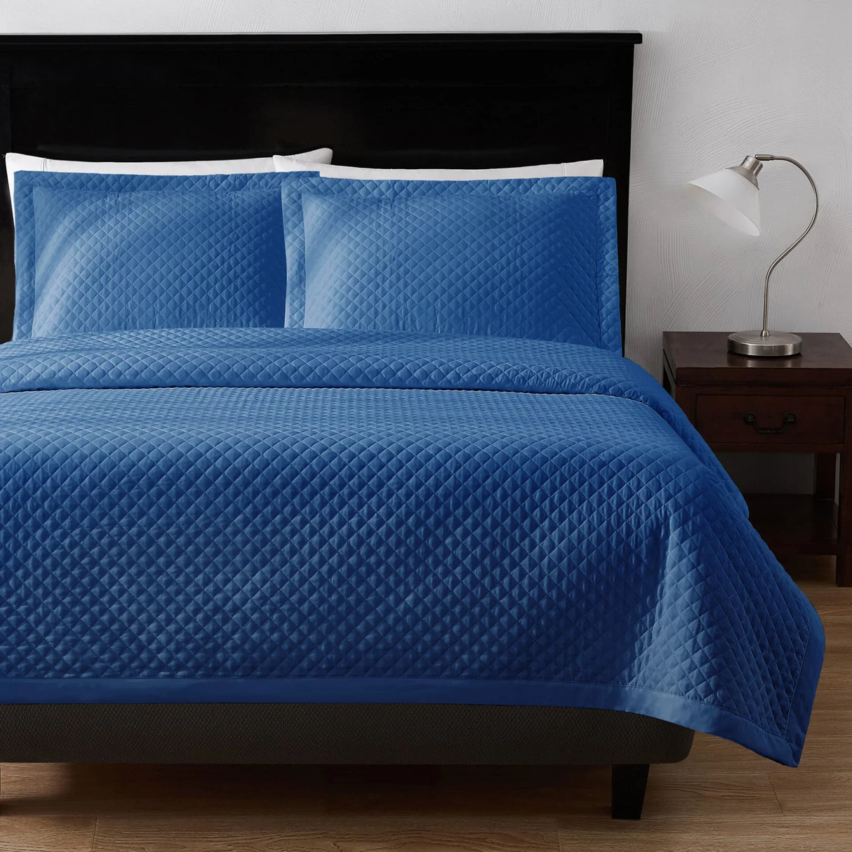 Product showcases a bed set in blue with diamond pattern stitching. By Boston Textile Co.