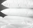 product shot of 3 pillows stacked on top of each other for hospitality and hotel wholesale supplier.