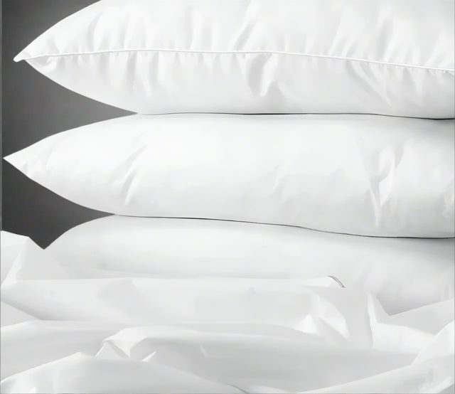 product shot of 3 pillows stacked on top of each other for hospitality and hotel wholesale supplier.