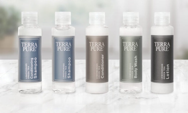 Terra pure full sample product display reading from left to right; conditioning shampoo, shampoo, conditioner, body wash and lotion. All displayed on a marble countertop in a bright lit room.