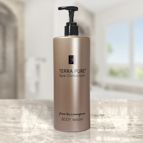 Product shot of the Terra Pure luxury hotel amenities body wash. Placed on a marble countertop in a bright lit room.