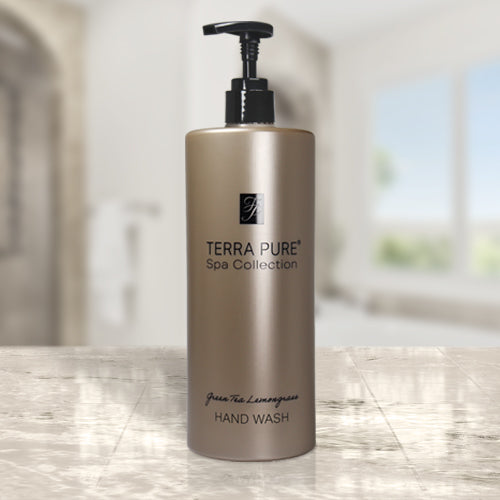 Terra Pure Spa Collection Hotel Amenities. Luxury hand wash. Product shot displayed on a marble countertop in a brightly lit room.