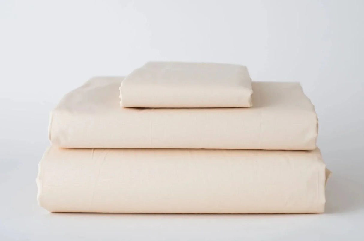 Product photo of a bed sheet set in beige/bone color. Product features pillowcases, fitted sheets and flat sheets.