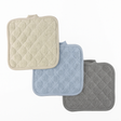 Three textured bath mats in beige, blue, and gray on a white background