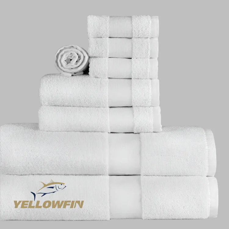 Stack of white towels with Yellowfin logo on a gray background