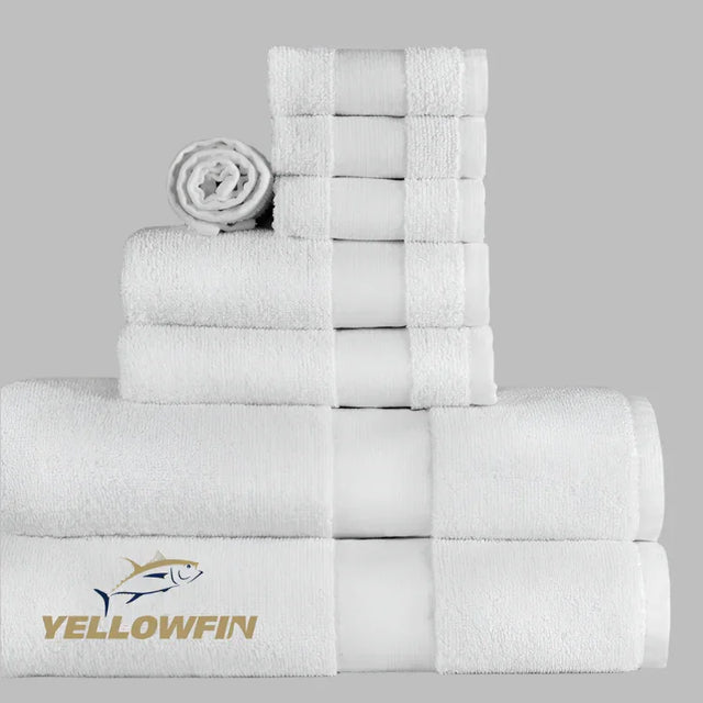 Stack of white towels with Yellowfin logo on a gray background