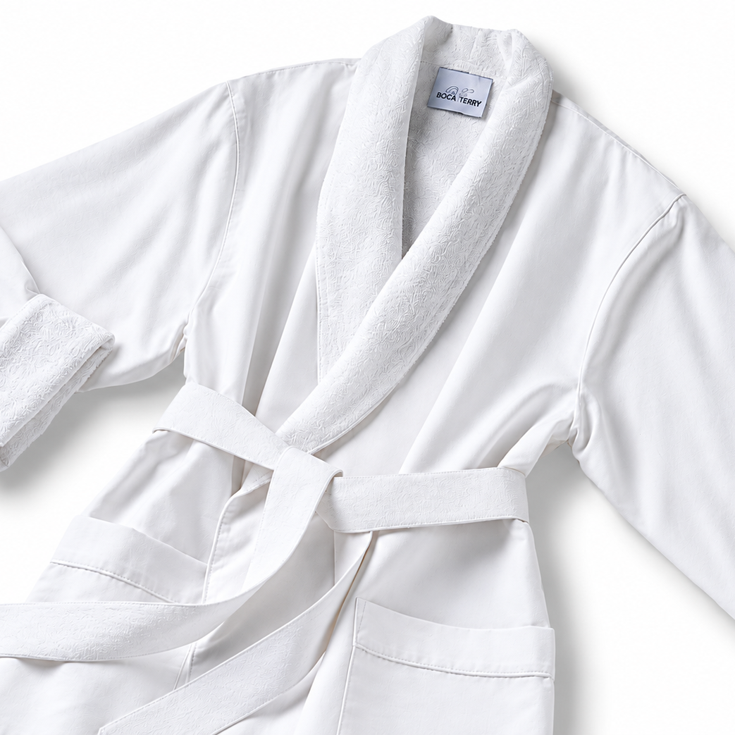 Pictured: White spa robe against a white background. This robe is the Microfiber Classic Shawl Collar Bathrobe. The inside of the robe and the collar are a fluffier material for maximum comfort.