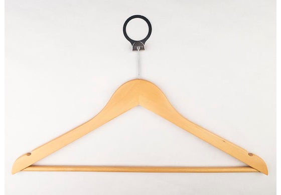 Wooden hanger with a black clip on a white background