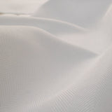 Close-up of textured white fabric with a subtle pattern
