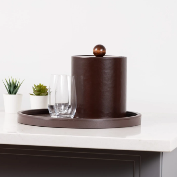 Decorative brown vase on a white surface with a white background