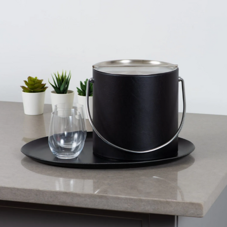 Black bucket on a gray countertop with a white wall background