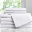 Pictured: Neatly folded stack of white sheets on a marble countertop in front of a window. The product featured are the Millennium T-300 Sheets.