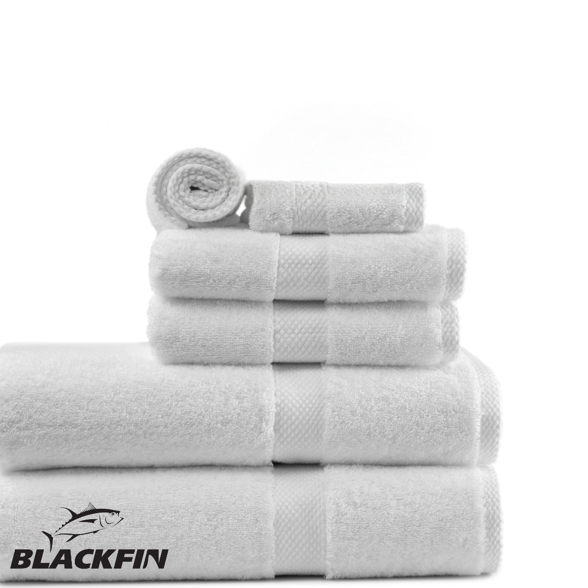 Pictured: Blackfin Towel Set by Boston Textile neatly folded and stacked based by size, with the largest towels on the bottom. The Blackfin logo can be seen on the bottom left corner.