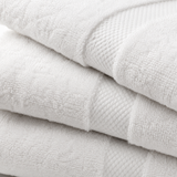 Stack of white towels with a textured surface