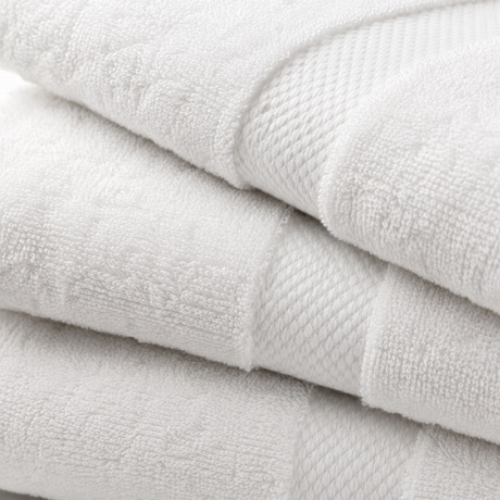 Stack of white towels with a textured surface