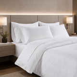 Neatly made bed with white bedding in a bedroom setting