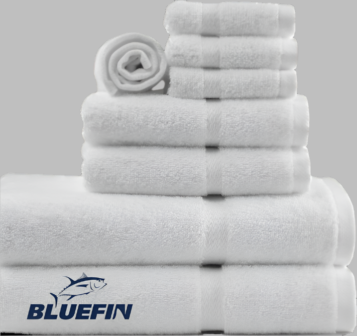 Product showcases variety of towels from the Bluefin collection by Boston Textile Co. Products are neatly rolled in order of size from wash cloths to hand towels to bath towels.