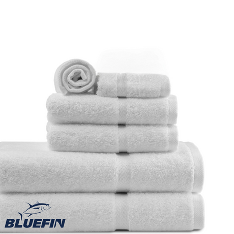 Stack of white towels with Bluefin logo on a white background